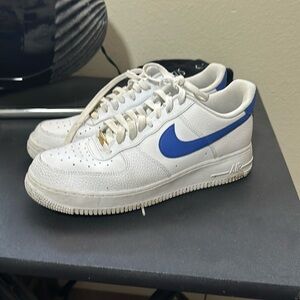White air forces with blue Nike logo